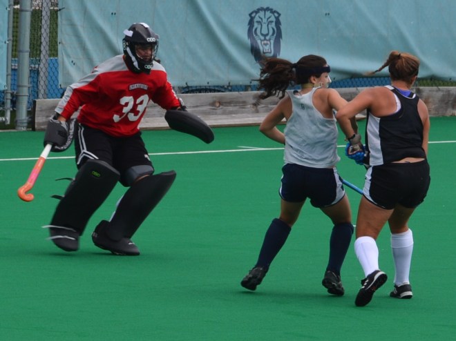 Kaitlyn Arnold and Hannah Millen protect the cage