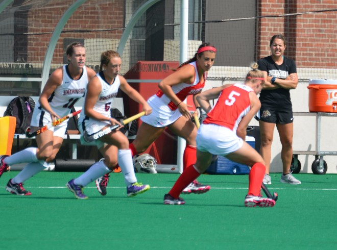 Rosie Shanks and Meg Lillis surround Ellie Landsman of Boston University
